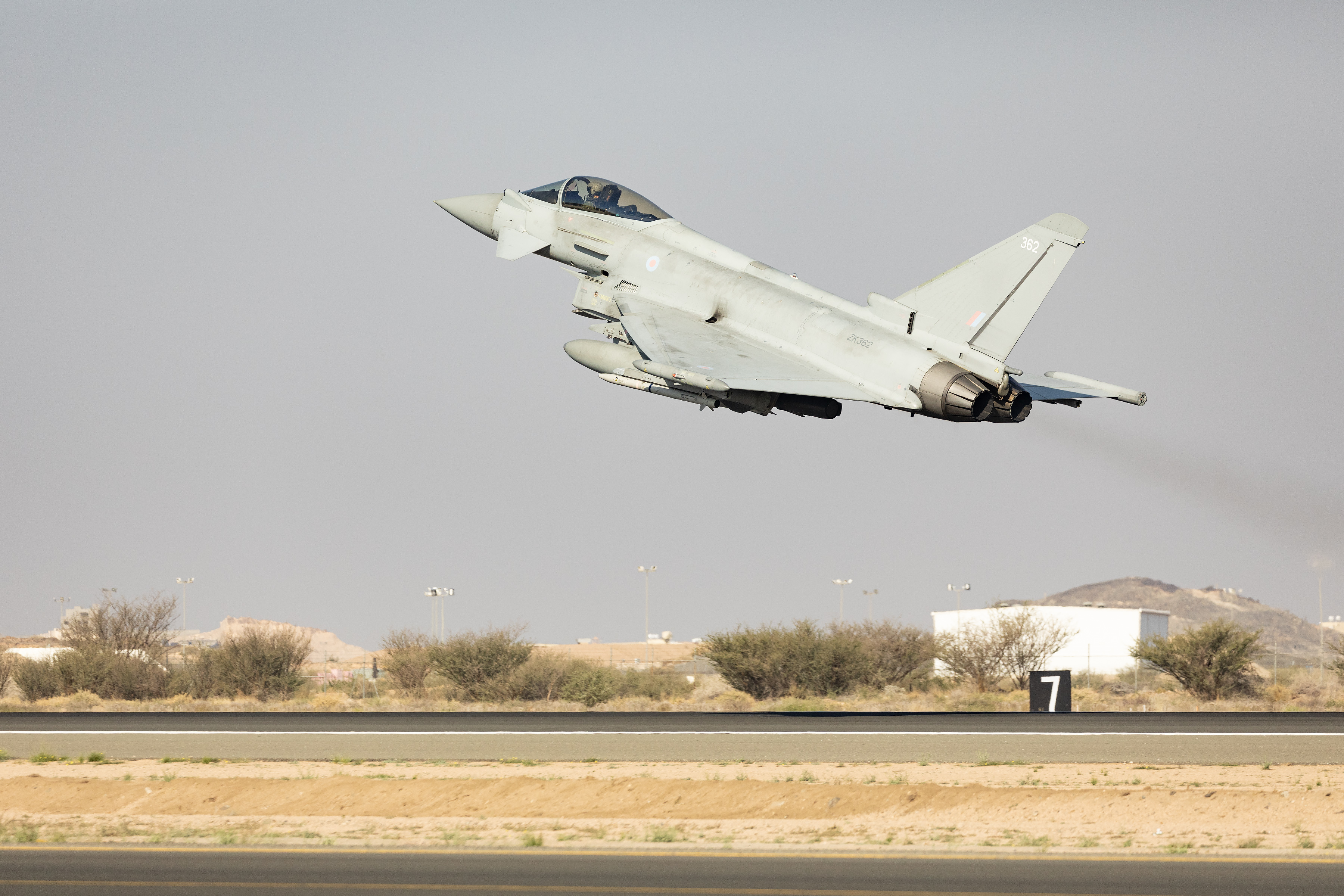 Image shows RAF Typhoon taking off from the airfield.